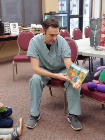 Dr Raines reading to children